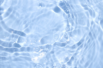 Tranquil Blue Water Surface with Gentle Ripples and Sparkling Light