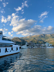 White double-deck yacht is moored at the seashore overlooking the mountains