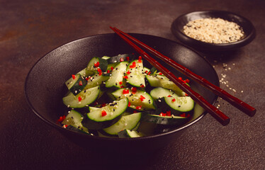 Chinese salad, cucumbers with chili pepper and sesame seeds, homemade, no people,