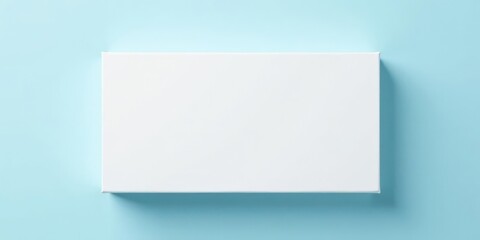 Fototapeta premium Blank rectangular white box on a light blue background, perfect for product placement and design mockups.