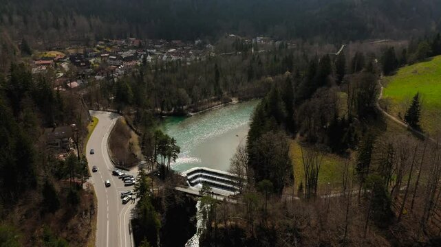 Lechfall, stunning waterfall in Fussen, Bavaria, captured from a high-angle drone shot. The scenic bridge, crystal-clear river, and picturesque landscape make it a perfect travel and photography spot