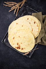 Lavash flat bread on green background