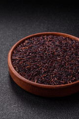 Red or brown raw rice in a ceramic bowl