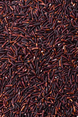 Red or brown raw rice in a ceramic bowl