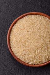 White raw rice in a ceramic bowl. Rice as an ingredient