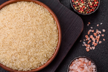 White raw rice in a ceramic bowl. Rice as an ingredient