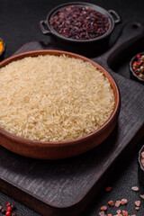 White raw rice in a ceramic bowl. Rice as an ingredient