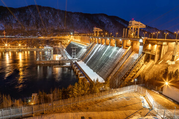 View of hydroelectric dam at dusk illumination winter