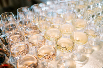 Rows of glasses with champagne stand on the table