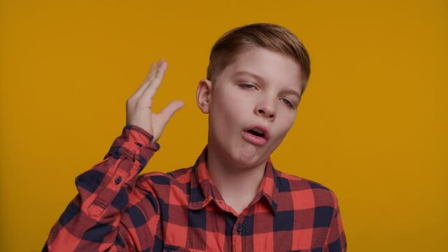 Boy Makes a 'Bla Bla' Gesture with his Hand near his Face, Expressing Boredom or Sarcasm