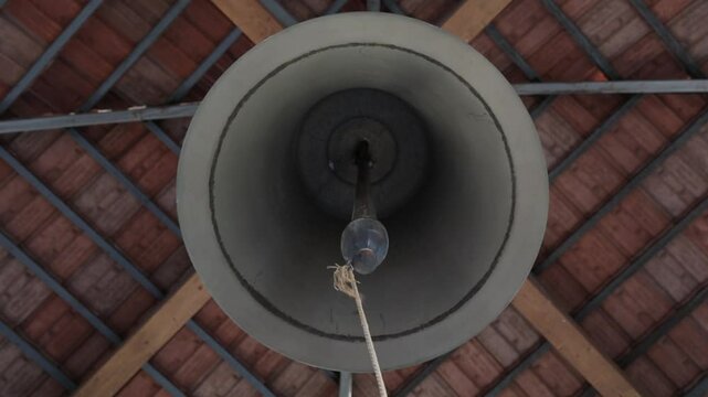 Low angle footage of ringing the bell of an Apostolic Armenian church during daytime, Armenia