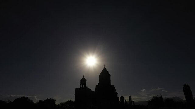 Pull-back silhouette, drone shot of people standing in front of Saghmosavank monastery, Armenia