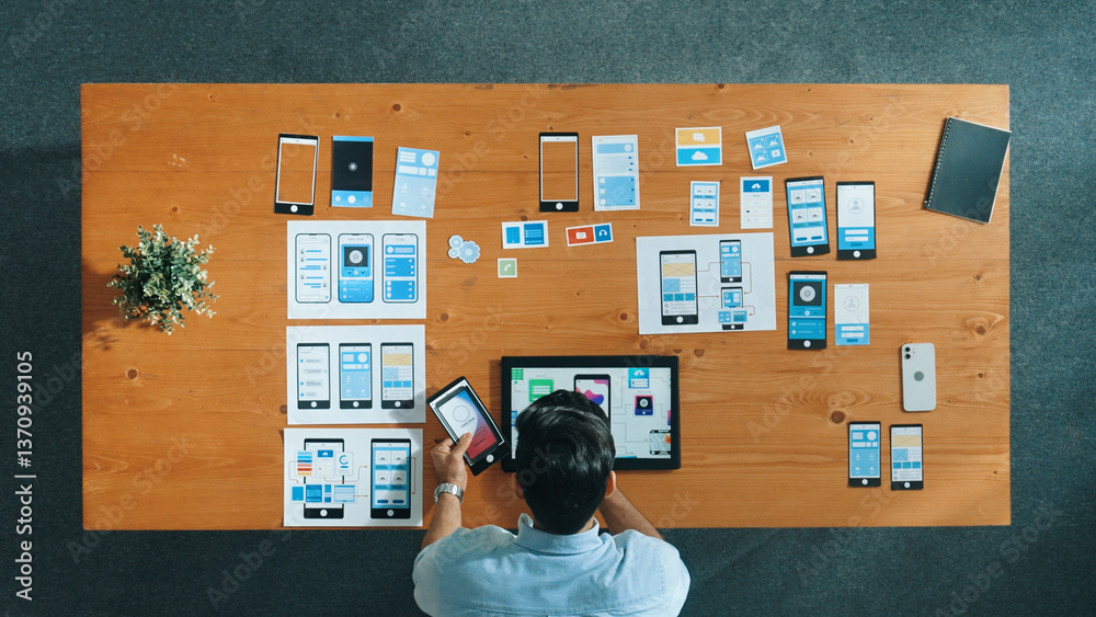 Wall mural top view of skilled developer walking and placing ux ui software. smart business man put tablet on m