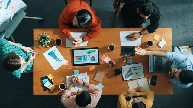 Top view of businesswoman hold tablet display financial graph and place on meeting table with sticky notes. Project manager looking at stock market statistic and analyzing data analysis. Convocation.