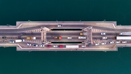 Highway bridge over blue sea or river with heavy traffic, Aerial view