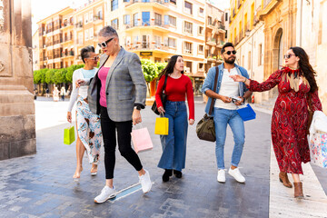 Fototapeta premium Group of diverse people walking and shopping in a city center