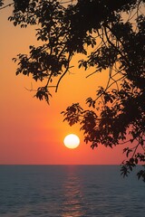 Fototapeta premium Sunset illuminates the ocean, with warm colors blending in the sky and reflecting on the water's