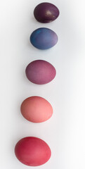 Easter eggs in purple and pink shades are lying on a white background with a shadow photo