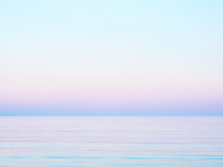Pastel gradient sky and calm sea