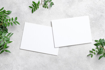 Two horizontal blank cards mockup on a textured concrete background, framed by vibrant green...