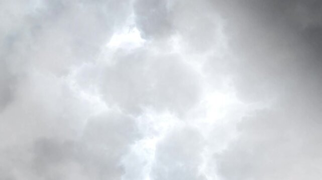 thick white clouds in the sky and thunderstorm