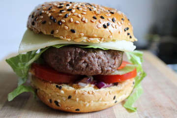 Tasty, delicious homemade burger on a wooden plate