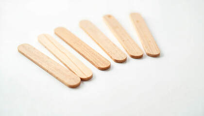 Crafting wooden sticks arranged on a white background  