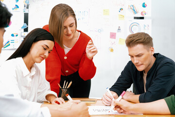 Happy cooperative multi-ethnic business group brainstorming discussion about marketing plan by...