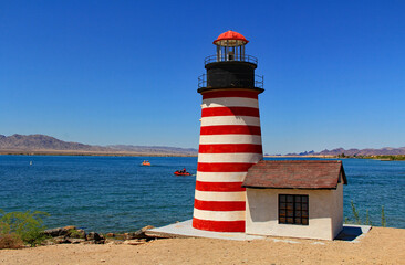 Replica of the West Quoddy Head lighthouse on the Bridgewater Channel in Lake Havasu City, Arizona, USA on lake Havasu with blue sky copy space.