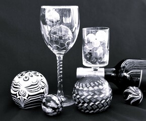 Black and white monochrome of wine glasses and marbles in a still life