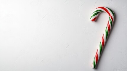 A beautifully styled candy cane rests against a minimalist background, symbolizing festive cheer, tradition, and sweet holiday memories in a charming and simplistic design.