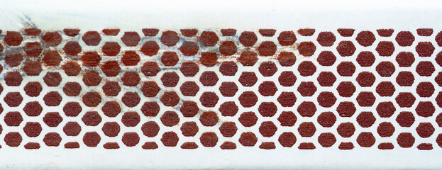 Extreme closeup of red phosphorus surface on side of matchbox, striking igniting matches concept,...