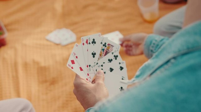 Friends Playing Cards at a Summer Picnic