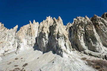 A white eroded rock formations near Bhraka village near Manang. Around Annapurna trekking, Himalaya, Nepal.