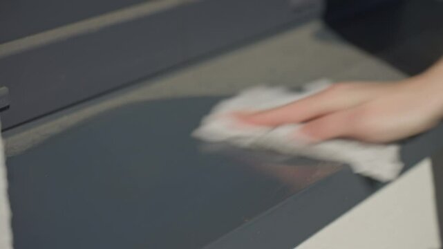 Hand removes dust from surface using cleaning cloth. Concept of spring cleaning and household chores