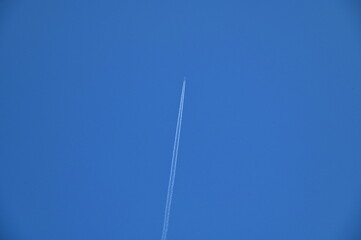 White Jet Contrail in a Blue Sky