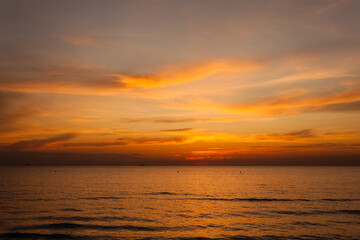 Beautiful bright stunning romantic sunset or sunrise on the horizon of clouds and the turbulent Black Sea of ​​the Krasnodar Territory in the tourist village of Anapa.