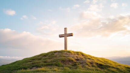 Simple wooden cross atop a grassy hill under a pastel sky
