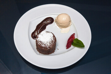 Delicious chocolate fondant with strawberry, chocolate sauce and walnut ice cream, desserts