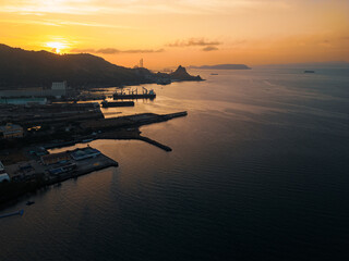 sunrise over an industrial port