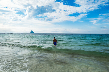 Andoya summer landscape with athletic male in the sea in northern Norway, Arctic Circle