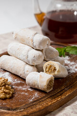 Walnut Roll Cake Slices with Teapot in the Background