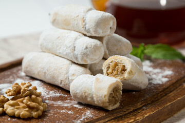 Walnut Roll Cake Slices with Teapot in the Background