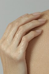 Woman's hand on shoulder, close-up