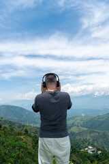 Naklejka premium A Mature Latino Man, with Gray Hair, Taking in the Breathtaking Scenery of the Colombian Mountains