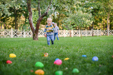 Children Hunting Easter Eggs in the Garden with Bunny Ears