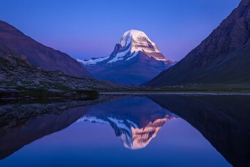 A beautiful mountain range at dusk, with the snow-capped Mount Kailash in the background and reflecting on the water, symbolizing peace of mind and spiritual enlightenment