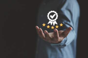 Businessman show best quality assurance with golden star. Quality control certificate and...
