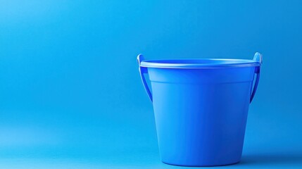 Bright blue plastic bucket against a solid blue background, ideal for cleaning or storage use
