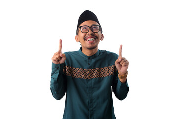 Look up here! Asian Muslim man pointing his finger up at empty copy space, isolated on a white...
